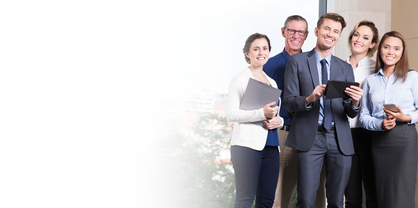 Group of professionals smiling and collaborating, showcasing teamwork in a modern office setting, relevant to customized group insurance solutions for businesses.