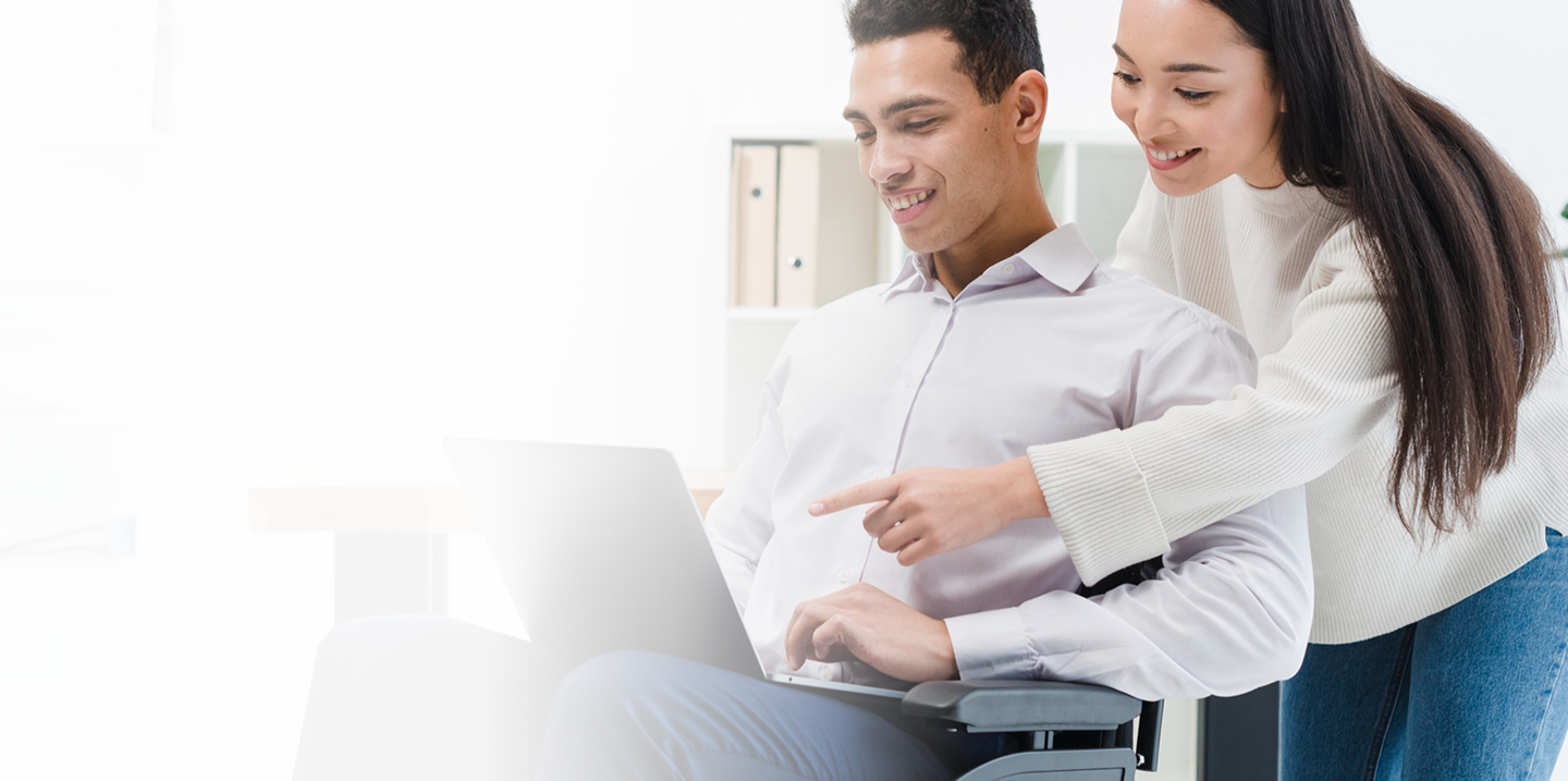 Man in wheelchair and woman discussing options on laptop, representing personalized disability insurance solutions for income protection.