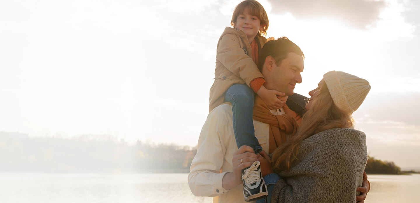 Family enjoying time together by the water, emphasizing love and protection, reflecting the importance of life insurance for families.