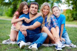 Young family outside smiling