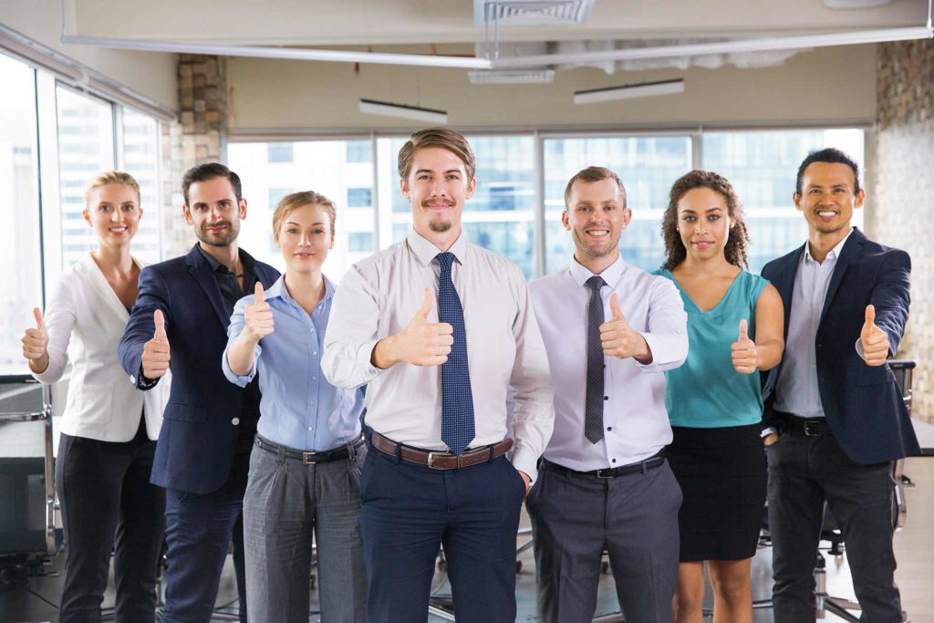 Insurance agents giving a thumbs up at the camera