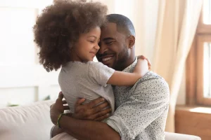 Father and daughter hugging, symbolizing family bonds and financial security in retirement planning.