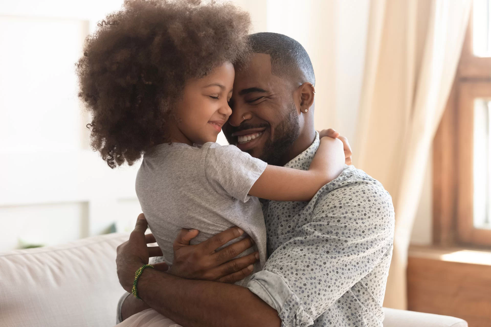 Father and daughter embracing joyfully, symbolizing family connections and love, relevant to life insurance discussions on protecting loved ones.