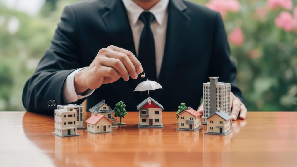 man holding an umbrella over miniature businesses