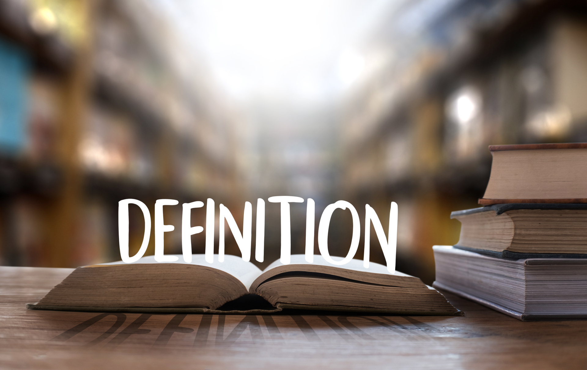 Open book with the word "DEFINITION" prominently displayed, symbolizing clarity in retirement terminology and financial planning.