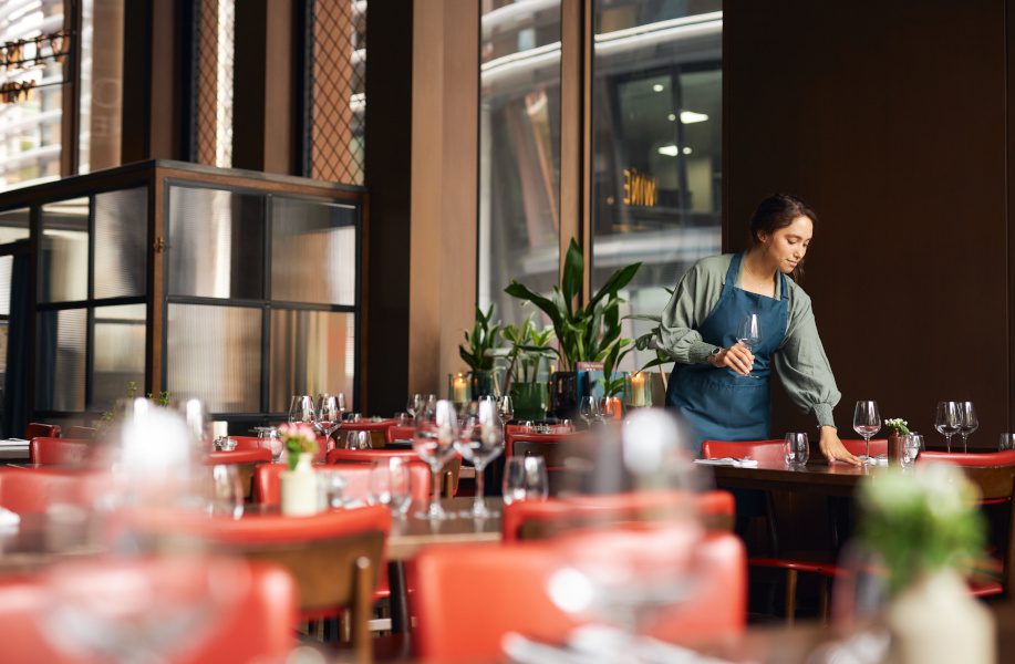 man setting up tables in a restaurant
