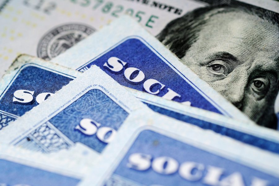 Social Security cards stack on money