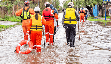 workers in a flooded street