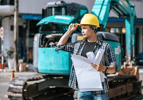 worker in front of heavy equipment