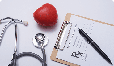 clipboard with Rx and a pen next to a plastic heart