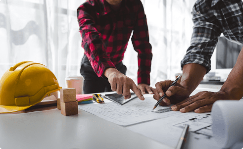 construction worker and foreman talking about blueprint