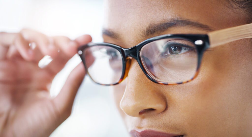 woman adjusting her glasses